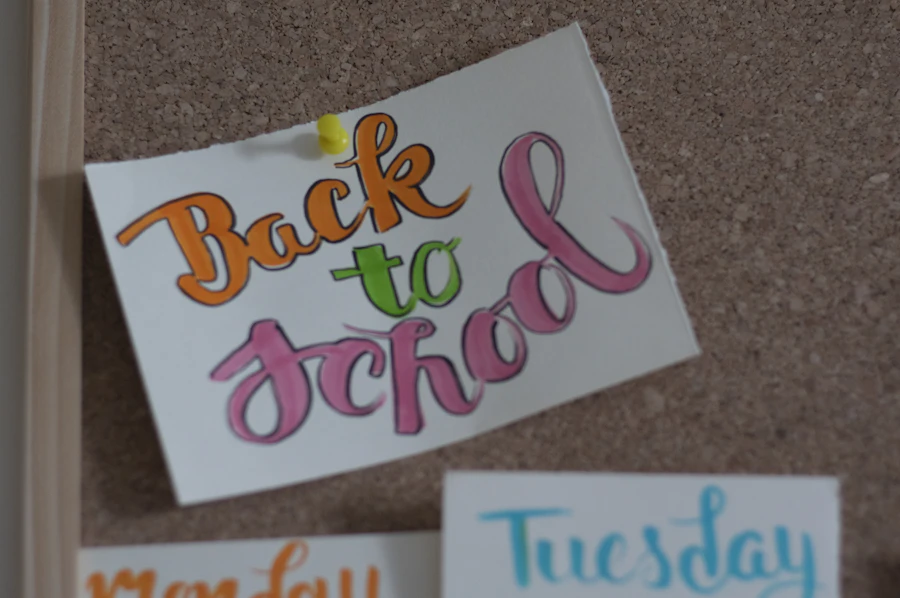 A back to school classroom bulletin board with hand-lettered cards
